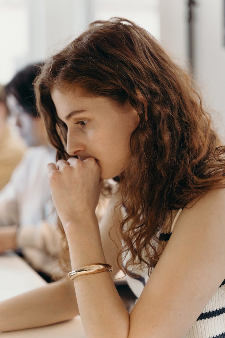 Woman In White Top Thinking