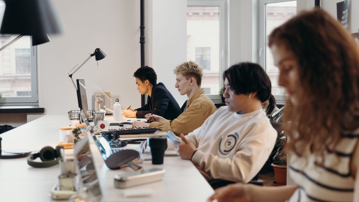 Young professionals working collaboratively in a modern office environment, fostering teamwork and innovation.