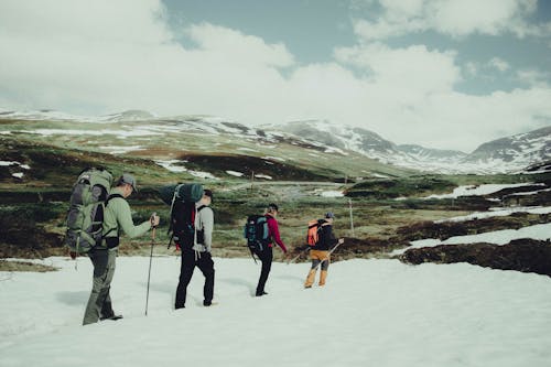 Free People Hiking on Snow Covered Mountain Stock Photo