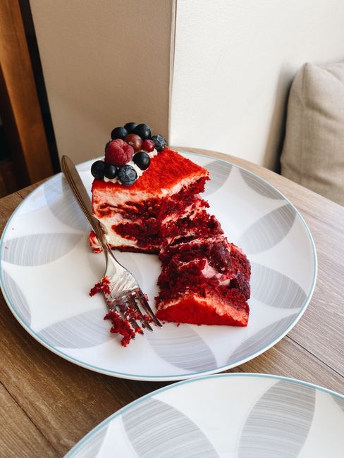 From above of tasty sweet cake with berries placed on plate on wooden table in daylight