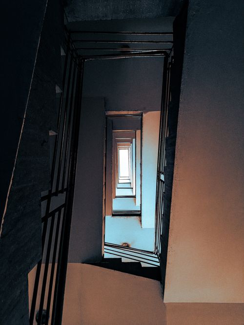 Free Creative view of a spiraling staircase interior with unique lighting. Stock Photo