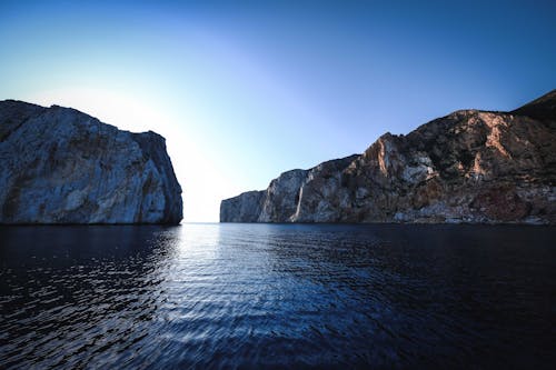 Amazing seascape with rocky cliffs and cloudless sky