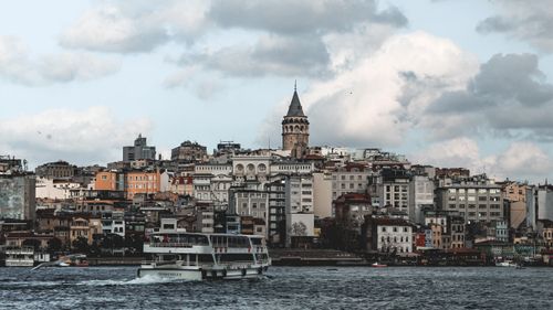 Free Explore the iconic Galata Tower and bustling ferry scene in Istanbul's urban landscape. Stock Photo