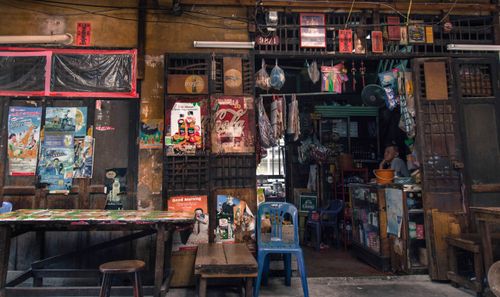 Free Rustic street shopfront with vibrant posters and traditional decor evokes nostalgic charm. Stock Photo
