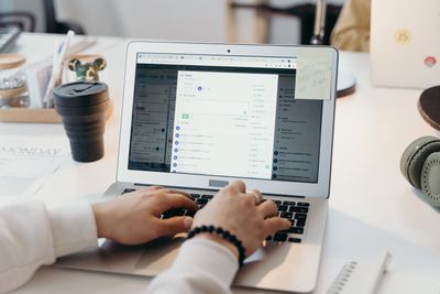 Person typing on a laptop in a bright modern office — photo by cottonbro studio on Pexels