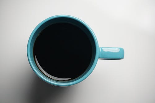 Free Overhead Shot of a Blue Mug with Black Coffee Stock Photo