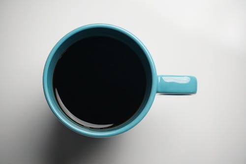 Overhead Shot of a Blue Mug with Black Coffee