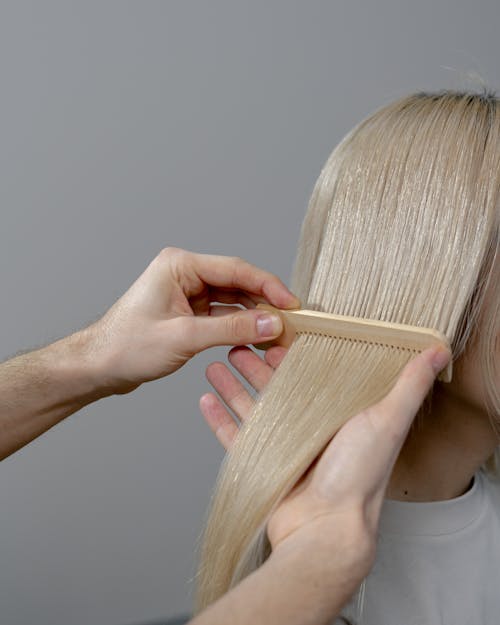 Free Hand Combing the Blonde Hair  Stock Photo