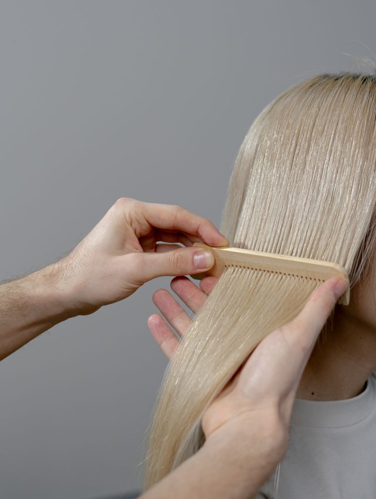 Hand combing blonde hair