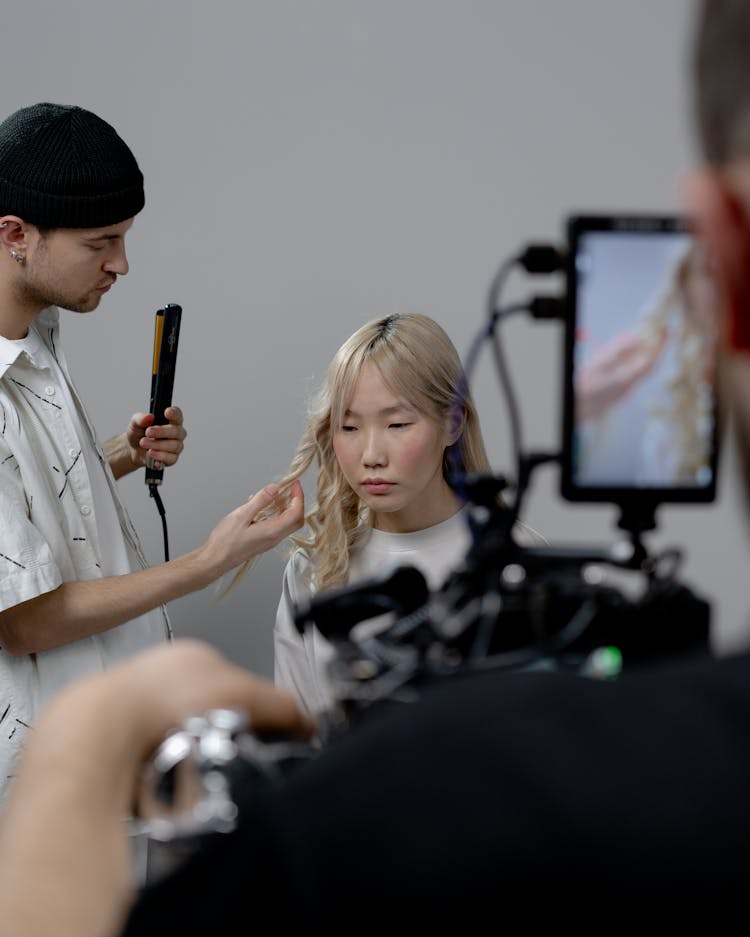 Photo Of A Man Curling A Woman's Hair