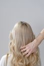 Photo of a Person's Hand Touching Blond Hair