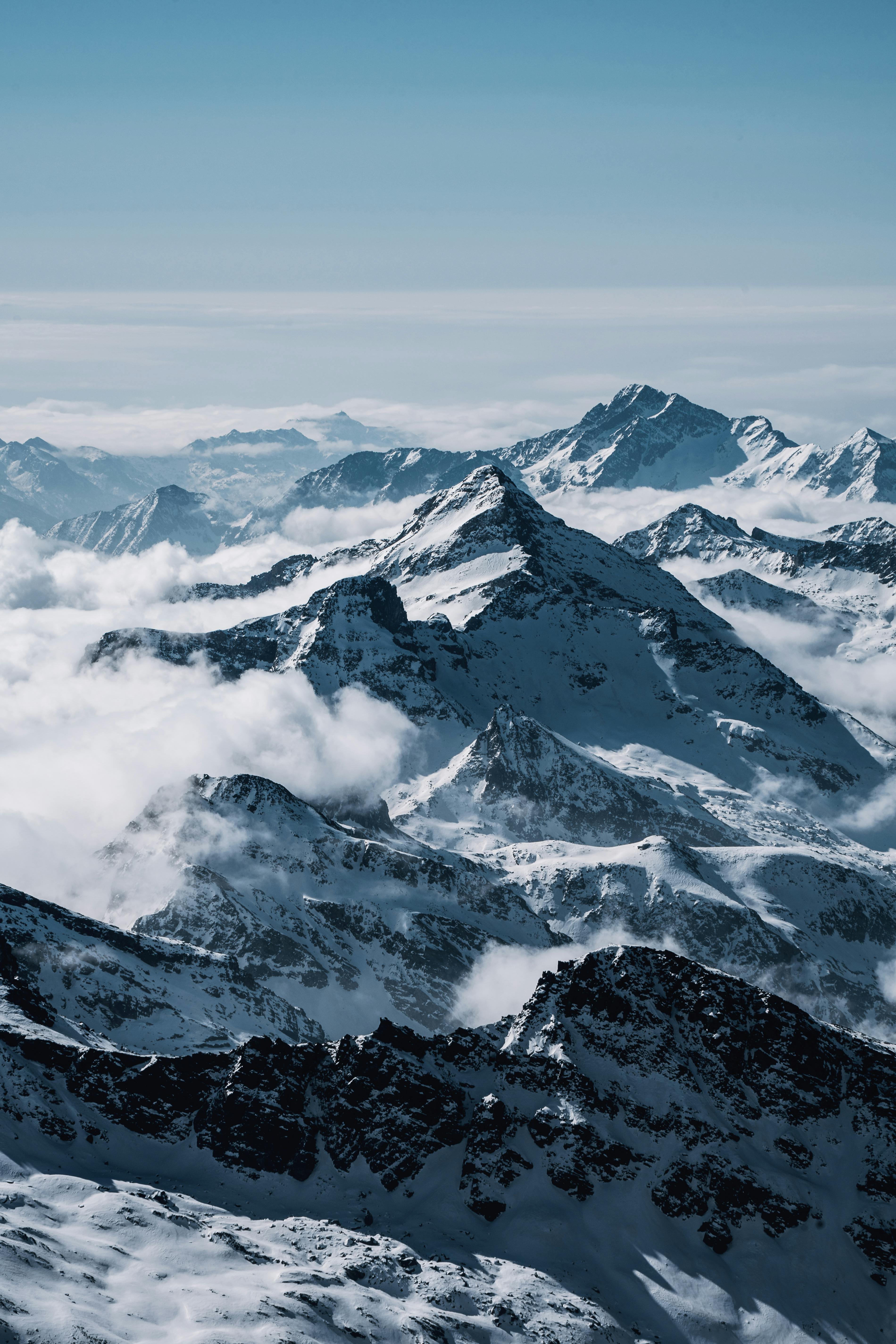 Prescription Goggle Inserts - Dramatic view of the snow-covered Swiss Alps under a clear sky, perfect for nature photography enthusiasts.