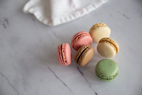 Close-Up Shot of Macarons on a White Surface