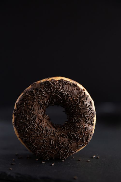 Free A tasty chocolate doughnut with sprinkles, perfect for dessert cravings. Stock Photo