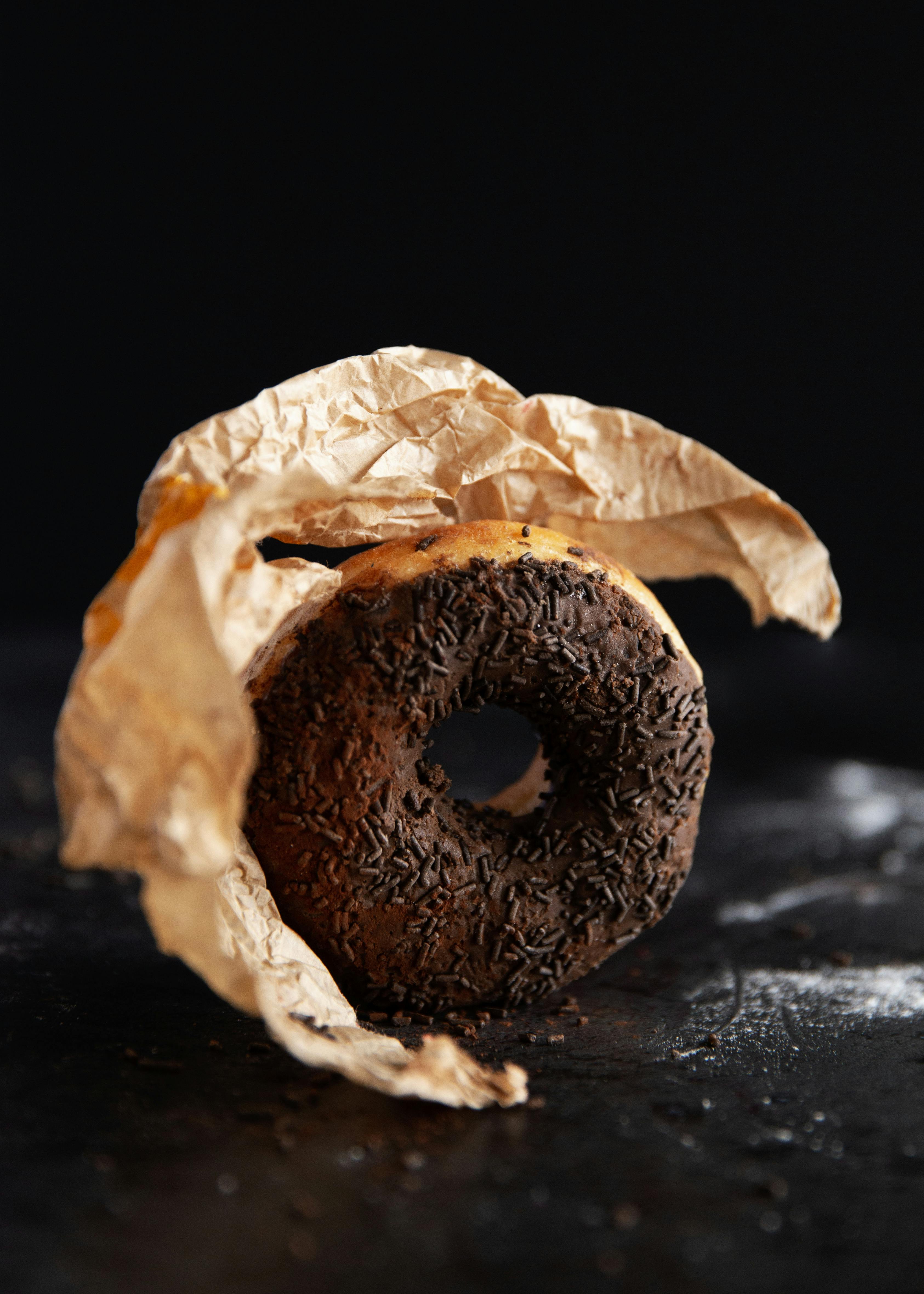 Mini pink glazed doughnuts in paper bag isolated on white Stock Photo by  ©Lena_Zajchikova 319122378