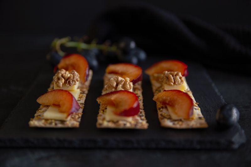 crackers topped with cheese and a smear of fig jam