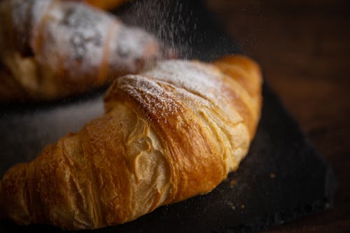 Free Close-Up Photograph of a Croissant with Powdered Sugar Stock Photo