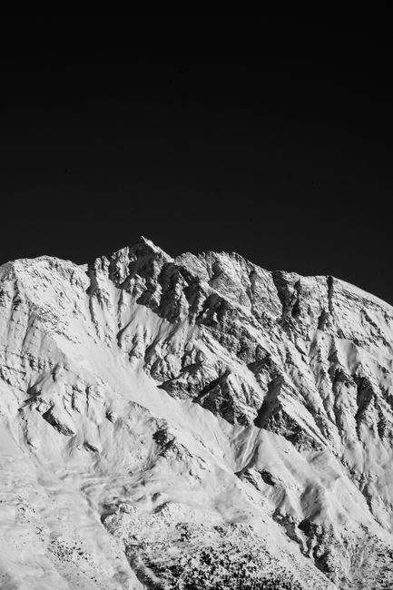 Striking black and white landscape of a snow-covered mountain in Switzerland.