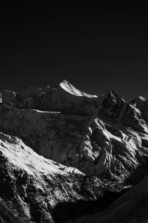 Free Stunning black-and-white photo of snow-covered mountains in Zermatt, capturing winter's dramatic beauty. Stock Photo