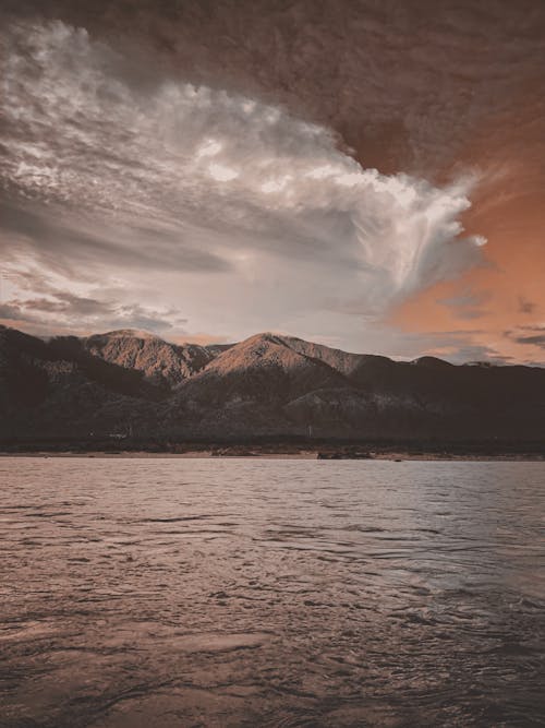 Free Mountains Beside Lake During Sunset Stock Photo