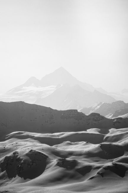 Monochrome view of snow-covered mountains in Swiss Alps during winter.