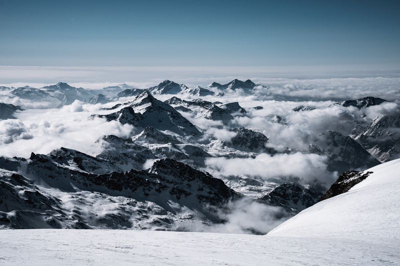 Snow-covered Alpine peaks glowing at sunrise above Zermatt