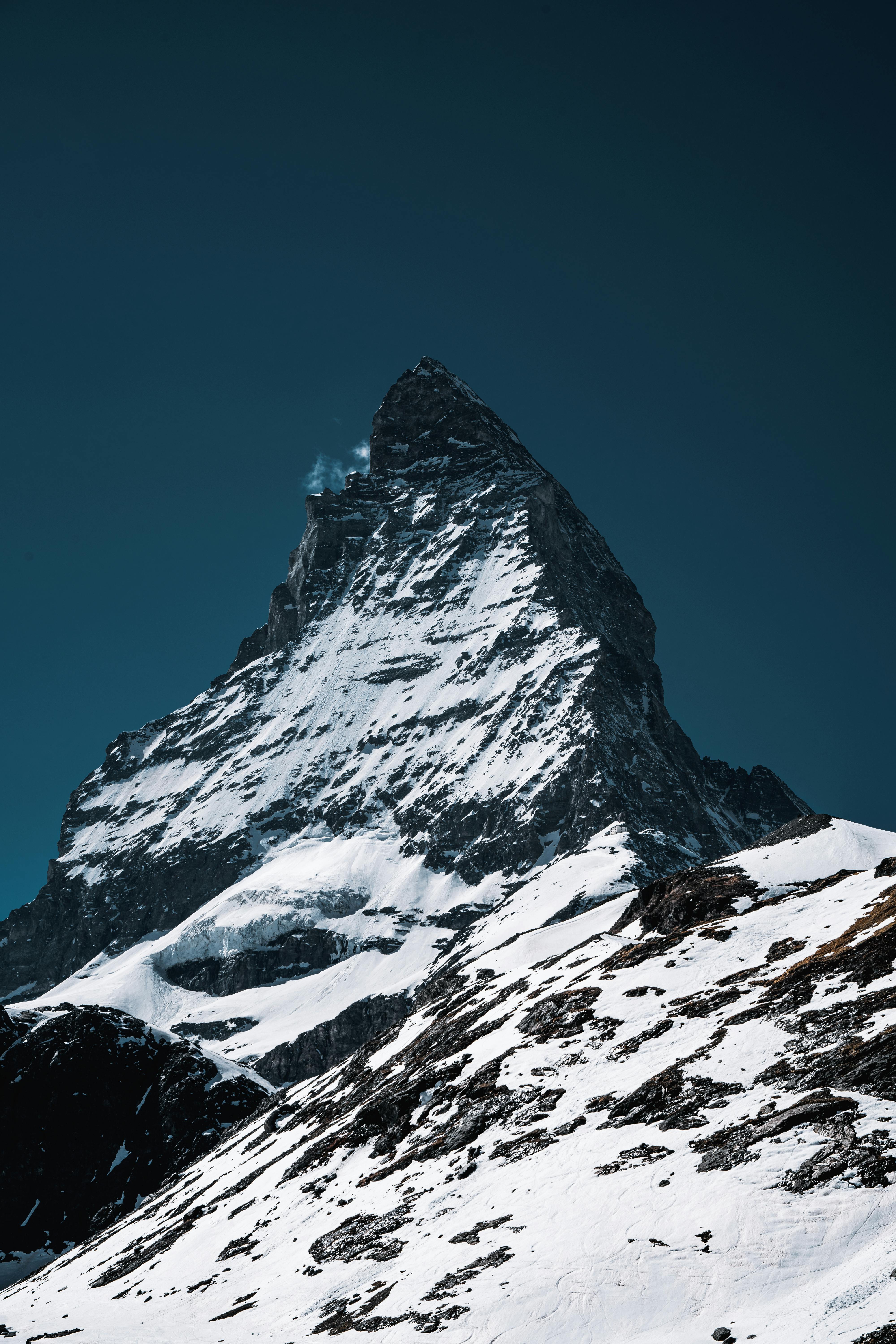 Breathtaking view of snow-covered Matterhorn peak under a clear blue sky in winter.