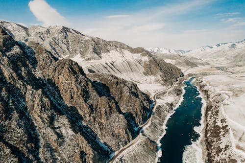 Aerial Photography of Mountains Covered by Snow under the Blue Sky