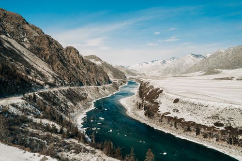 Free Scenic winter landscape of a river flowing through Altai Mountains in Russia. Stock Photo