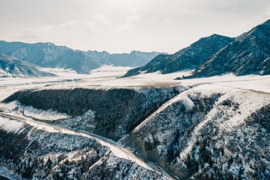 Stunning aerial view of snow-dusted mountains in Ongudaysky District, Altai, Russia.
