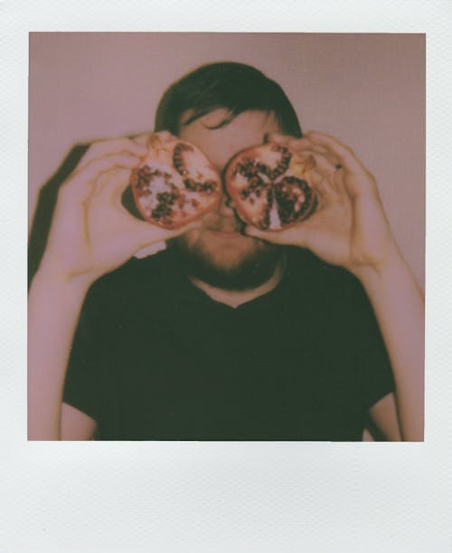 Man Holding Pomegranate Fruit