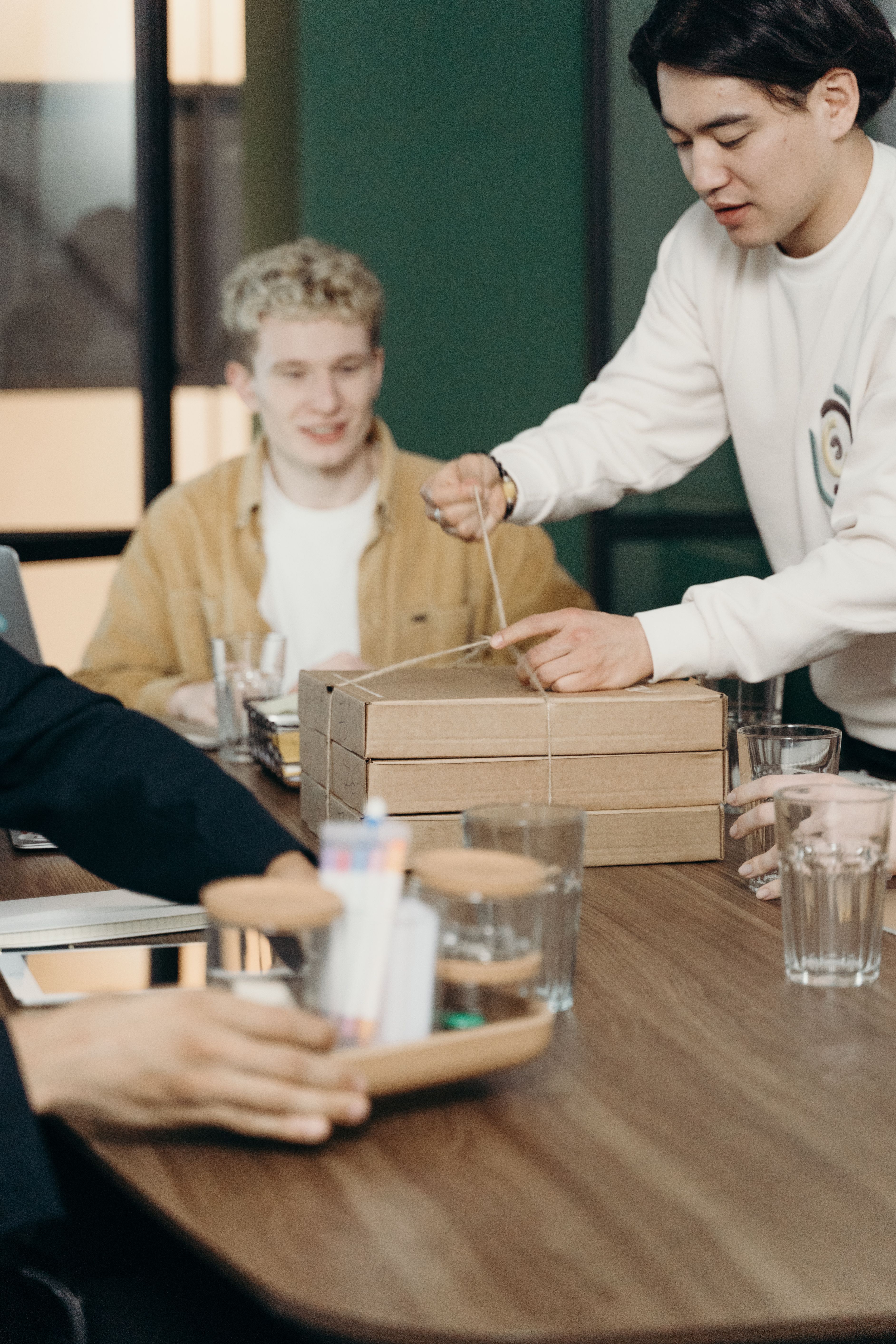 A diverse group of colleagues share a casual lunch during a break at the office.