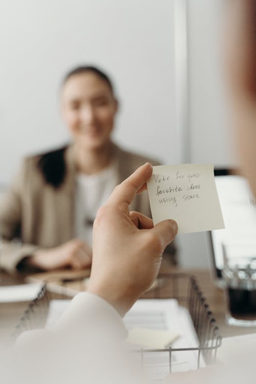Free Person Holding a Sticky Note Stock Photo