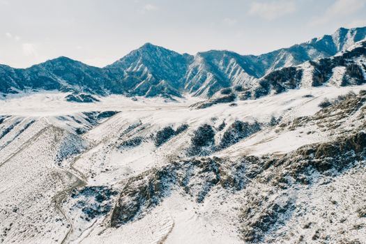 Stunning aerial photo capturing snow-covered mountains in a winter view of Russia.