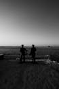 Silhouette of 2 Person Standing on the Beach