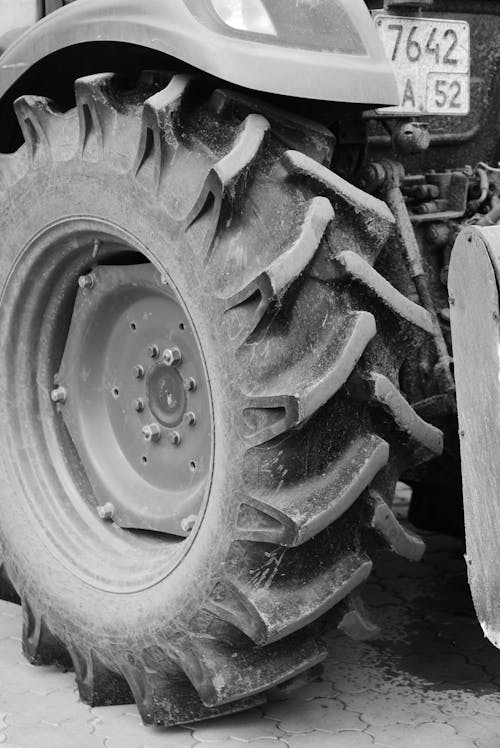 Grayscale Photo of a Tractor Wheel