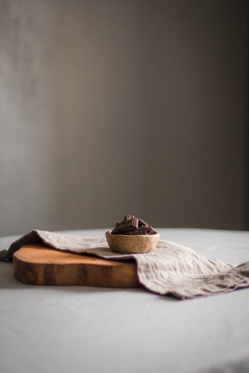 Free Sweet dark chocolate tart served on wooden board on round table in light room Stock Photo