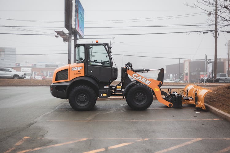 Modern Tractor Parked On Asphalt Road On Street