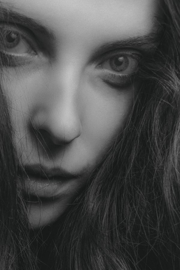 Dramatic close-up portrait showing defined brows and eyes