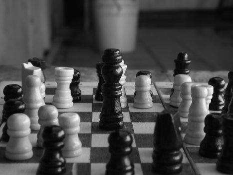 Black and white close-up of a chess game in progress, showcasing strategy and focus.