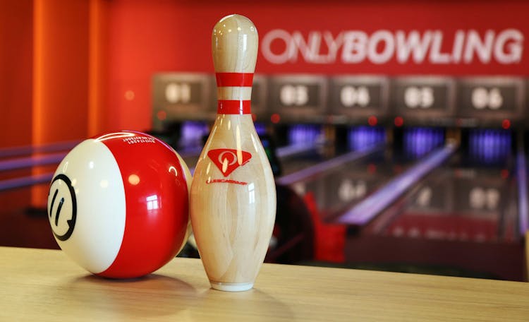 Selective Focus Photograph Of A Bowling Ball Beside A Bowling Pin