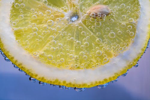 Free Macro Shot of a Slice of Lemon with Water Bubbles Stock Photo