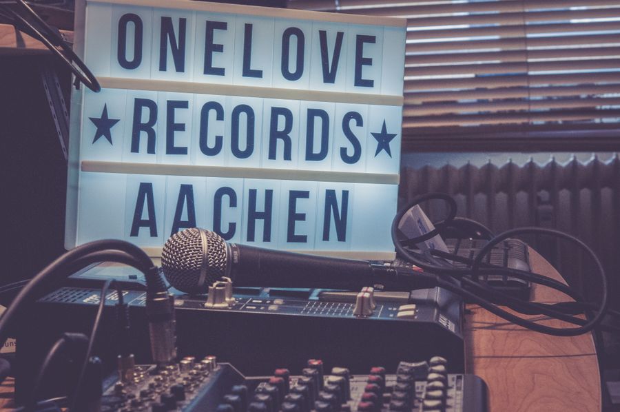 Studio desk with mixer, microphone, and warm lighting
