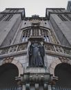 From below fragment of exterior of historic stone building of St Benedict monastery with clocks and statue located in Sao Paulo city in Barzil