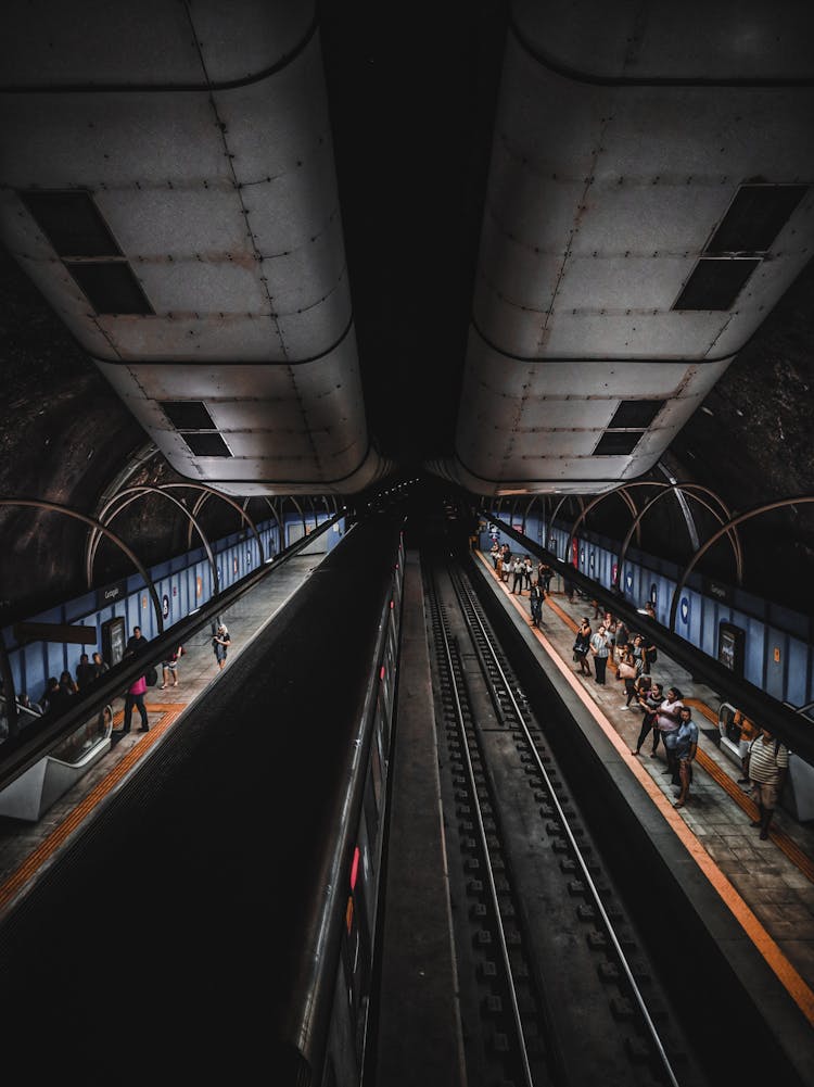 People Waiting For Train In Subway Station