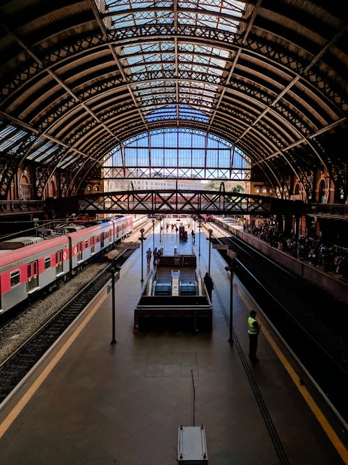 Unrecognizable tourists in urban train station with escalators