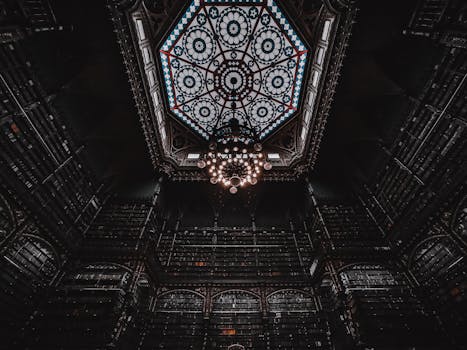 Majestic library interior in Rio de Janeiro, featuring ornate chandelier and elaborate ceiling design.