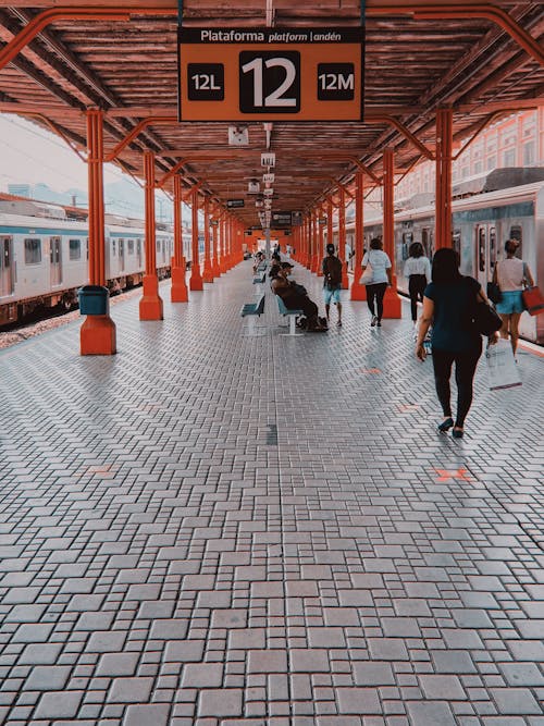 Anonymous people walking on roofed passage of railway station