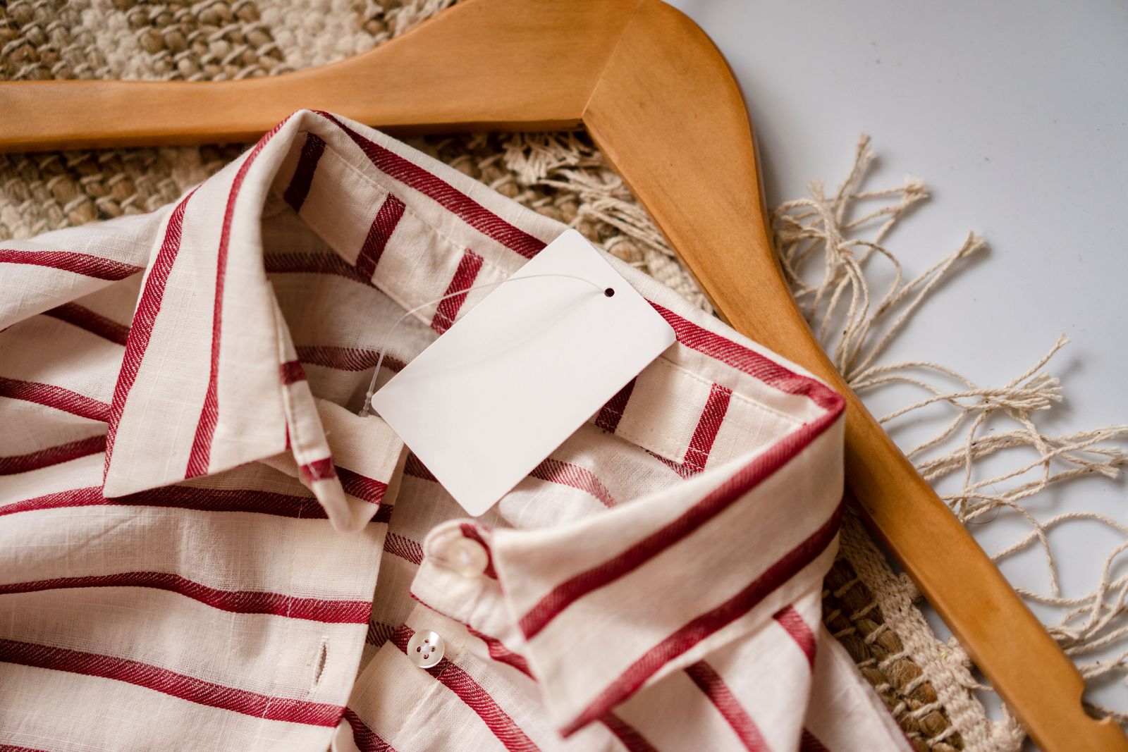 Striped shirt on wooden hanger with blank label and no people