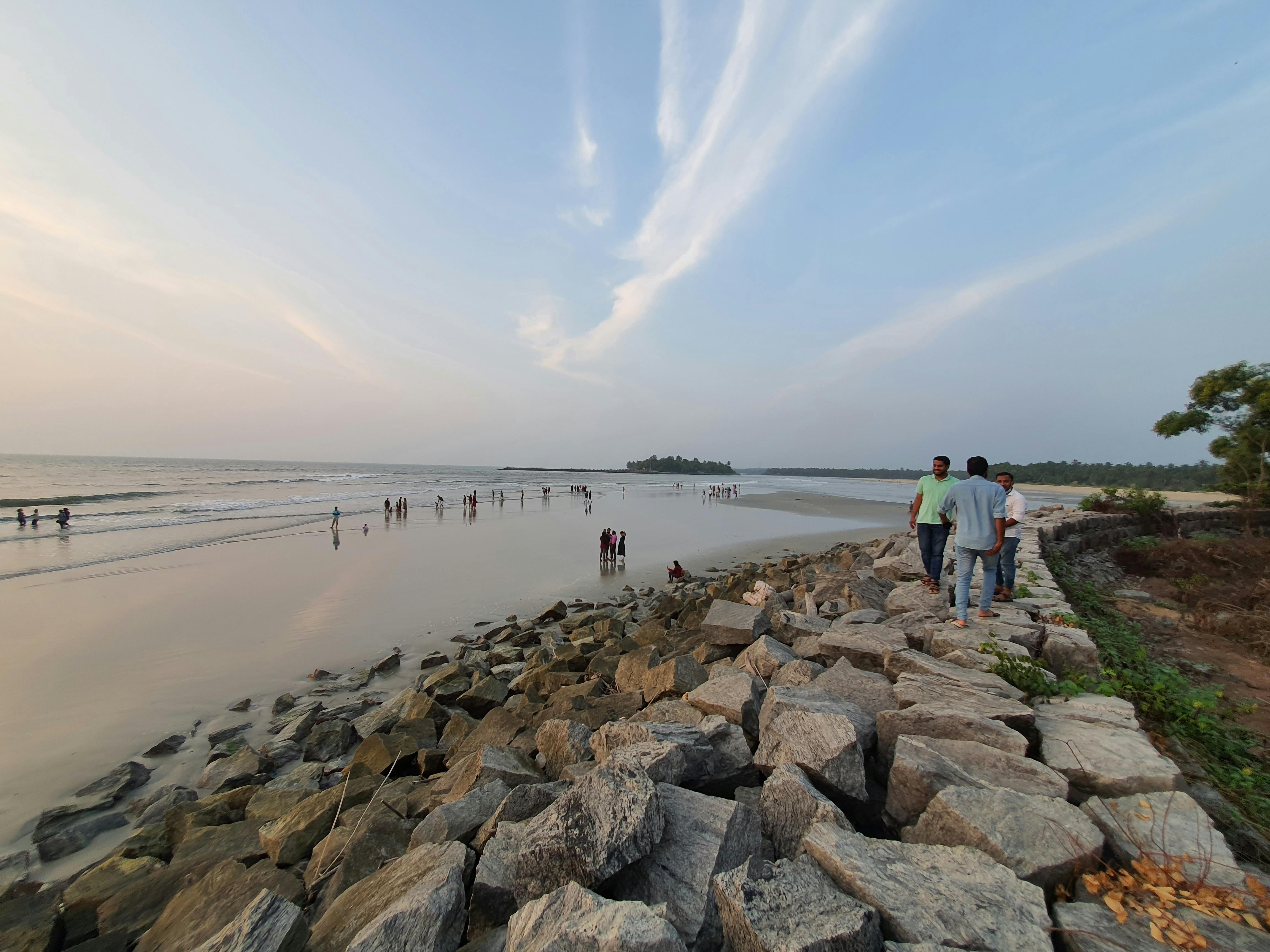 Person relaxing with coffee, journal, and candles on a cozy table